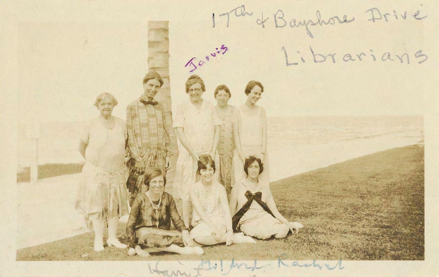 Group of women standing in front of palm tree