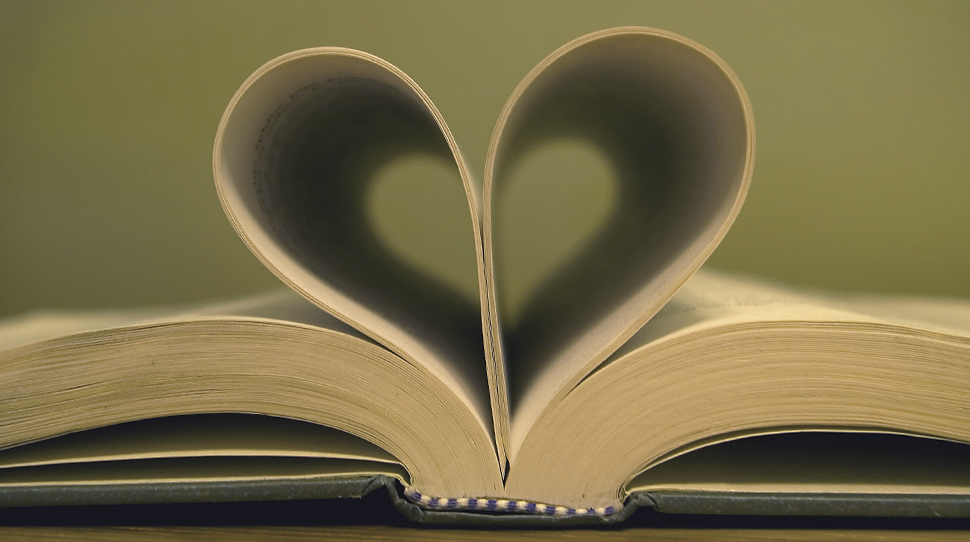 Open book with pages curled in the shape of a heart